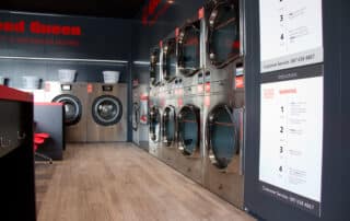A laundry room featuring a decorative sign that reads Speed Queen, adding a cozy touch to the space.