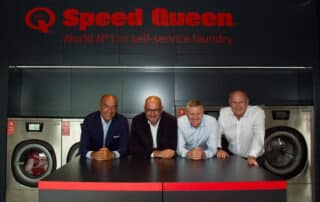 People celebrating the 1,000th opening Ireland Speed Queen Store, the world's first self-service laundry.